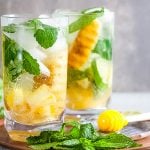 2 glasses of Grilled Pineapple Mojitos with mint and honey