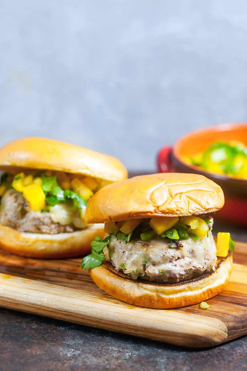 A platter of Jamaican jerk burgers topped with pineapple salsa. 