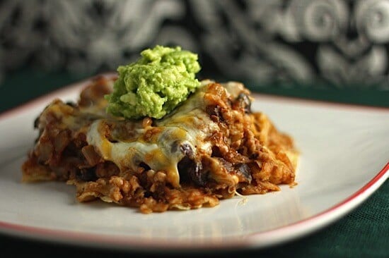 portion of taco bake topped with guacamole on a plate