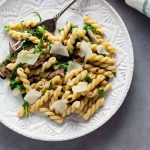 Gemelli with Mushrooms and Arugula on a plate