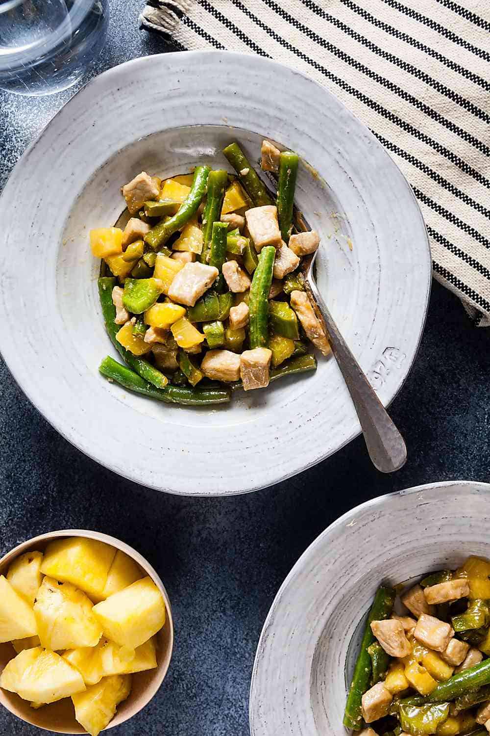 Sweet and Sour Pork Stir Fry in a white bowl. 