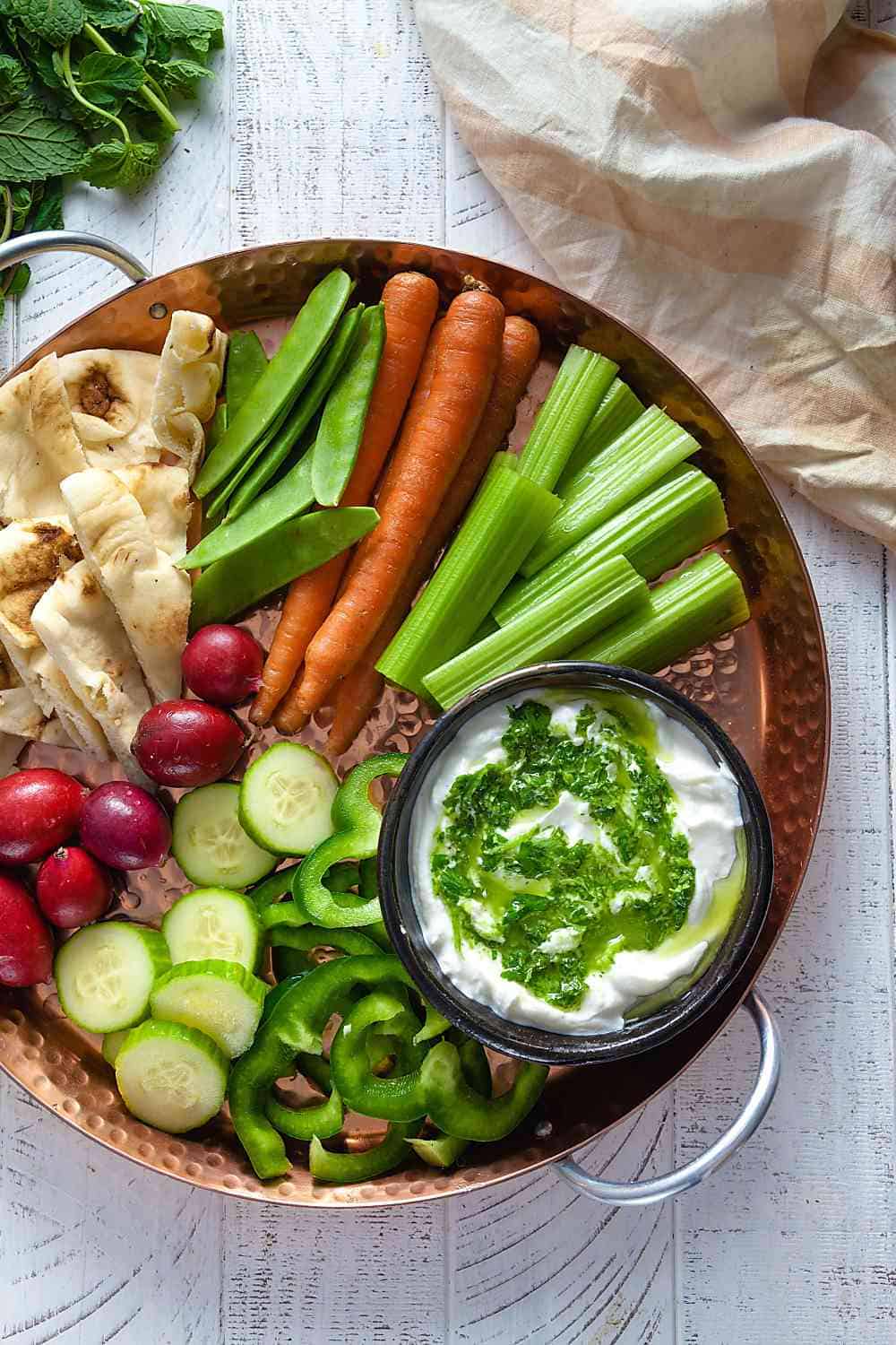 big veggie tray with greek yogurt dip and naan