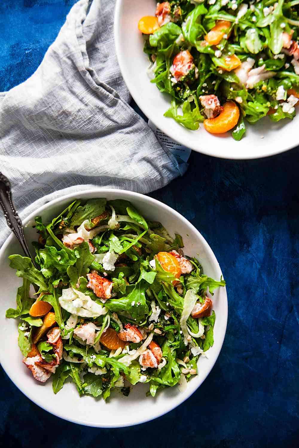 Two bowls of Lobster Farro Salad on a blue background 