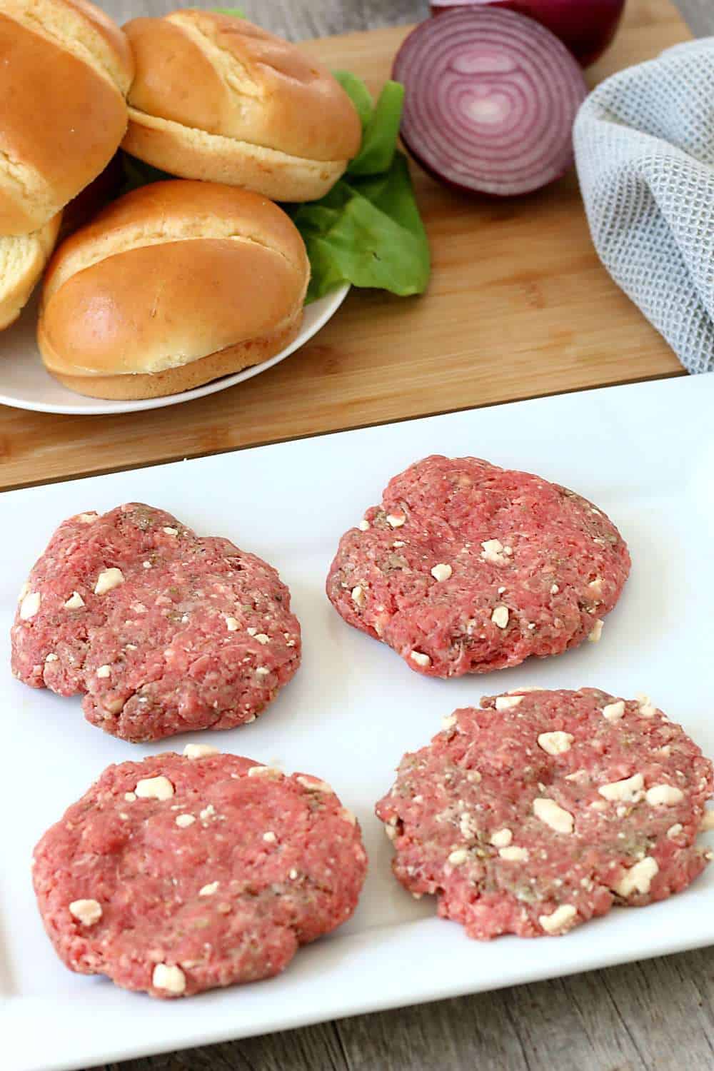 Patties formed for this homemade burger recipe. These feta cheese burgers are ready to be grilled.