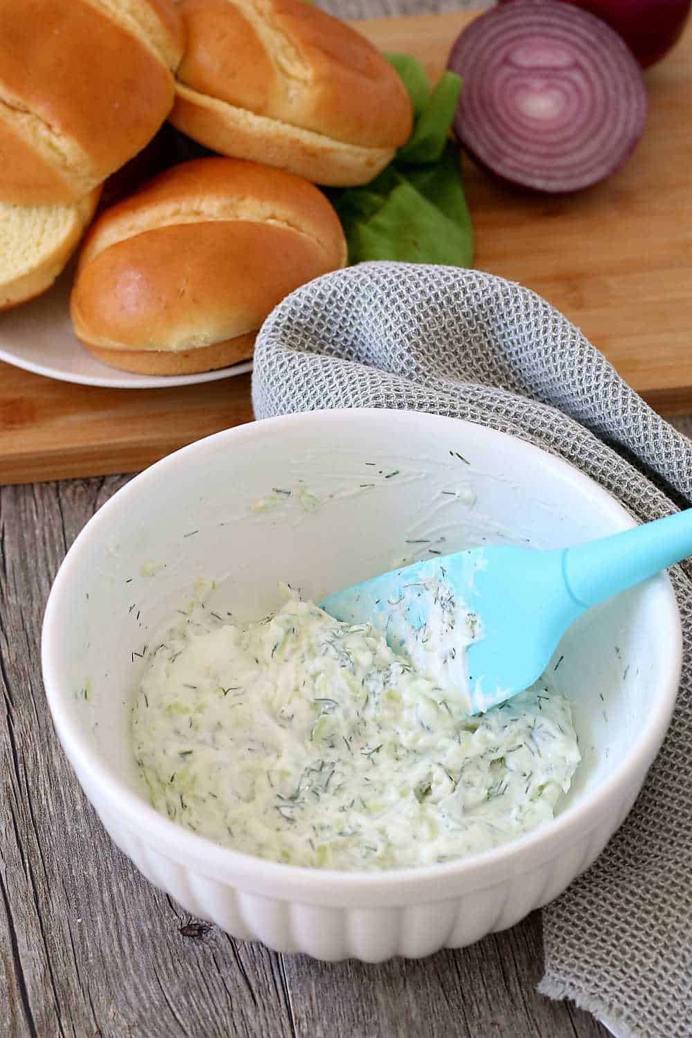 Greek burgers wouldn't be the same without the homemade tzatziki topping which is being mixed up here! 