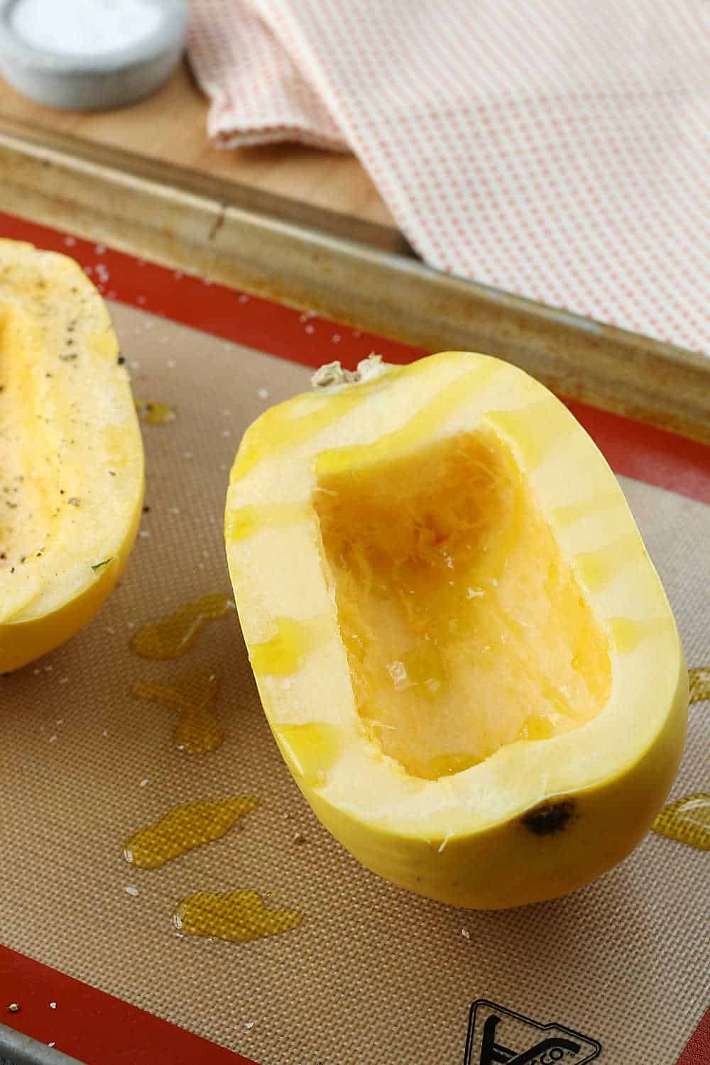 Seasoning the baked spaghetti squash is the next step when learning how to cook spaghetti squash in the oven. 