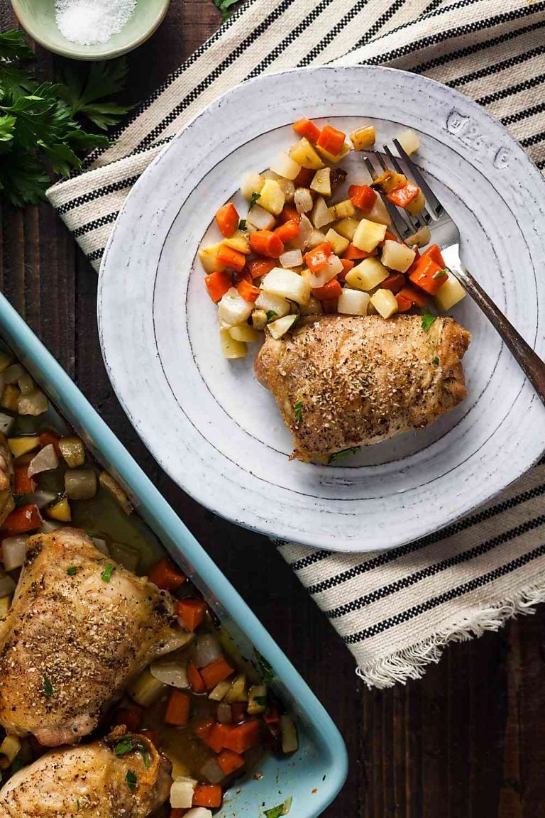 crispy sheet pan chicken thighs with root vegetables on a plate