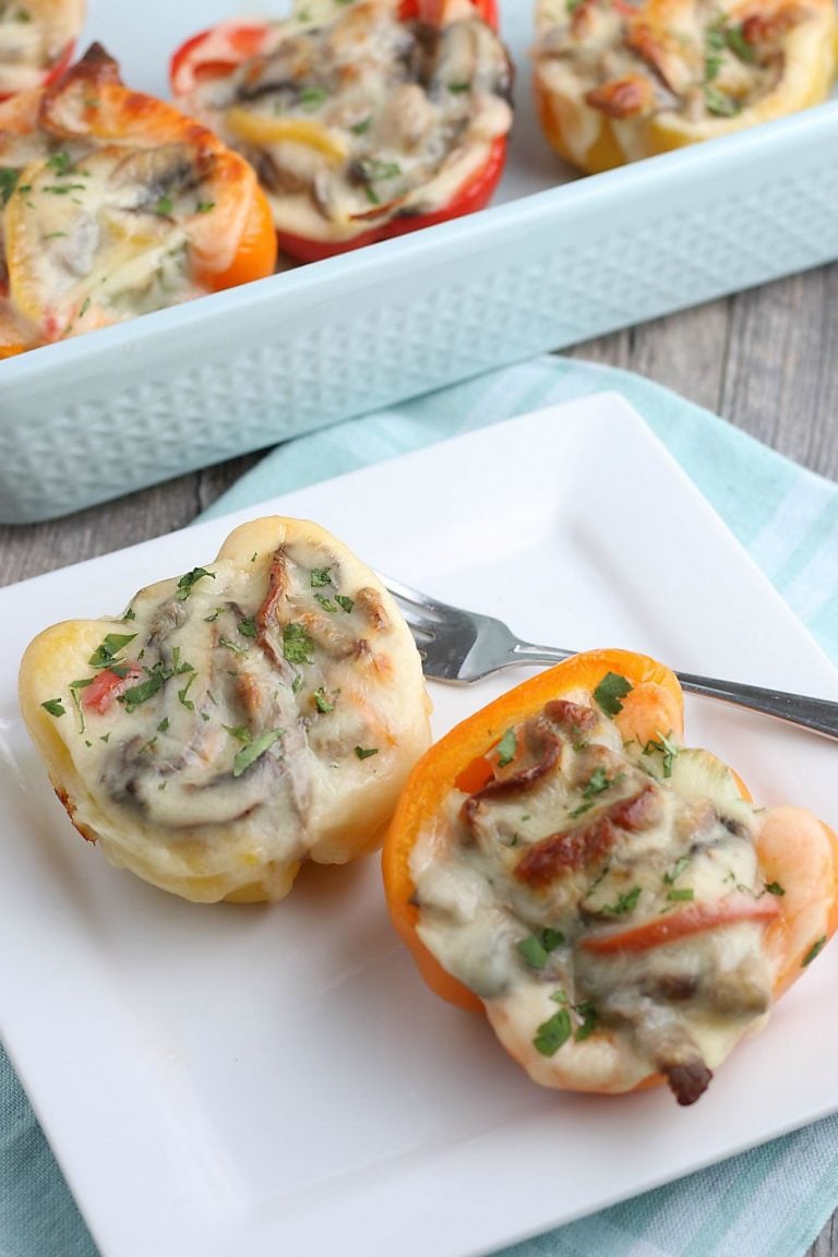 A look at two stuffed peppers on a plate ready to be enjoyed or shared.
