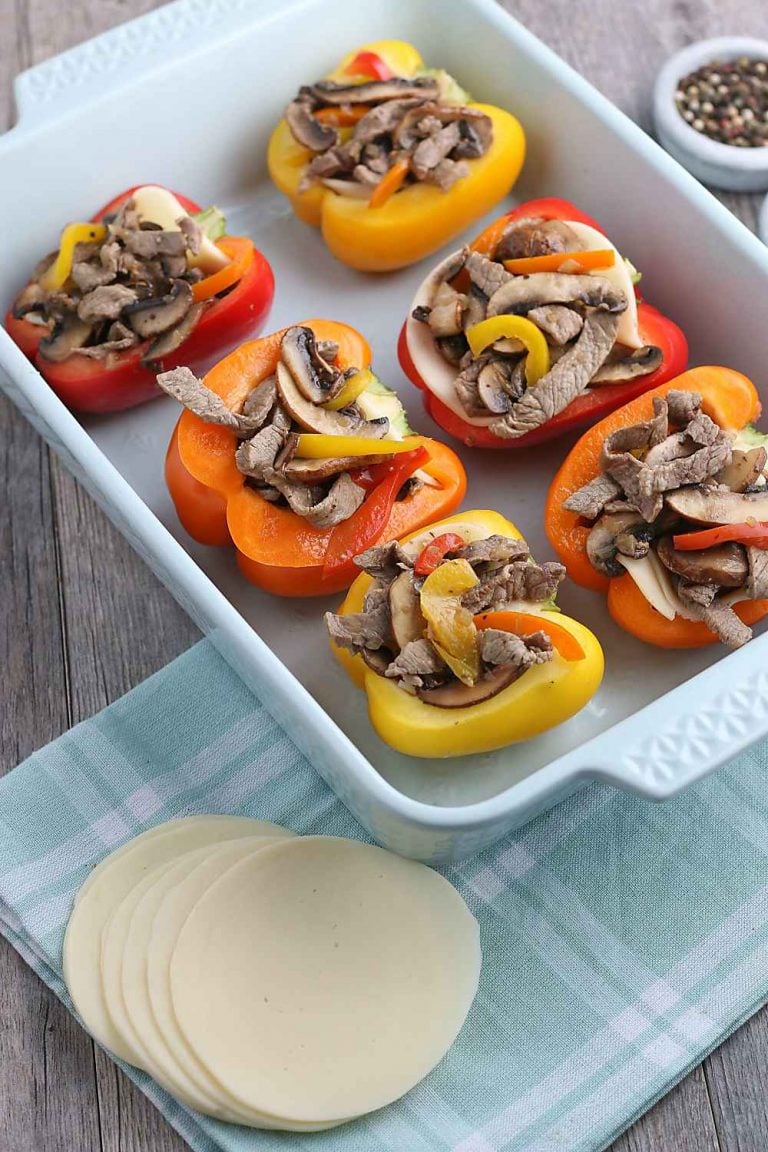 Now the filling for our stuffed peppers is added to the peppers in a pan, ready to be topped with cheese and baked.