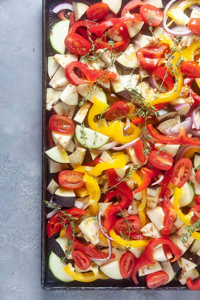 Sliced fresh vegetables on a sheet pan