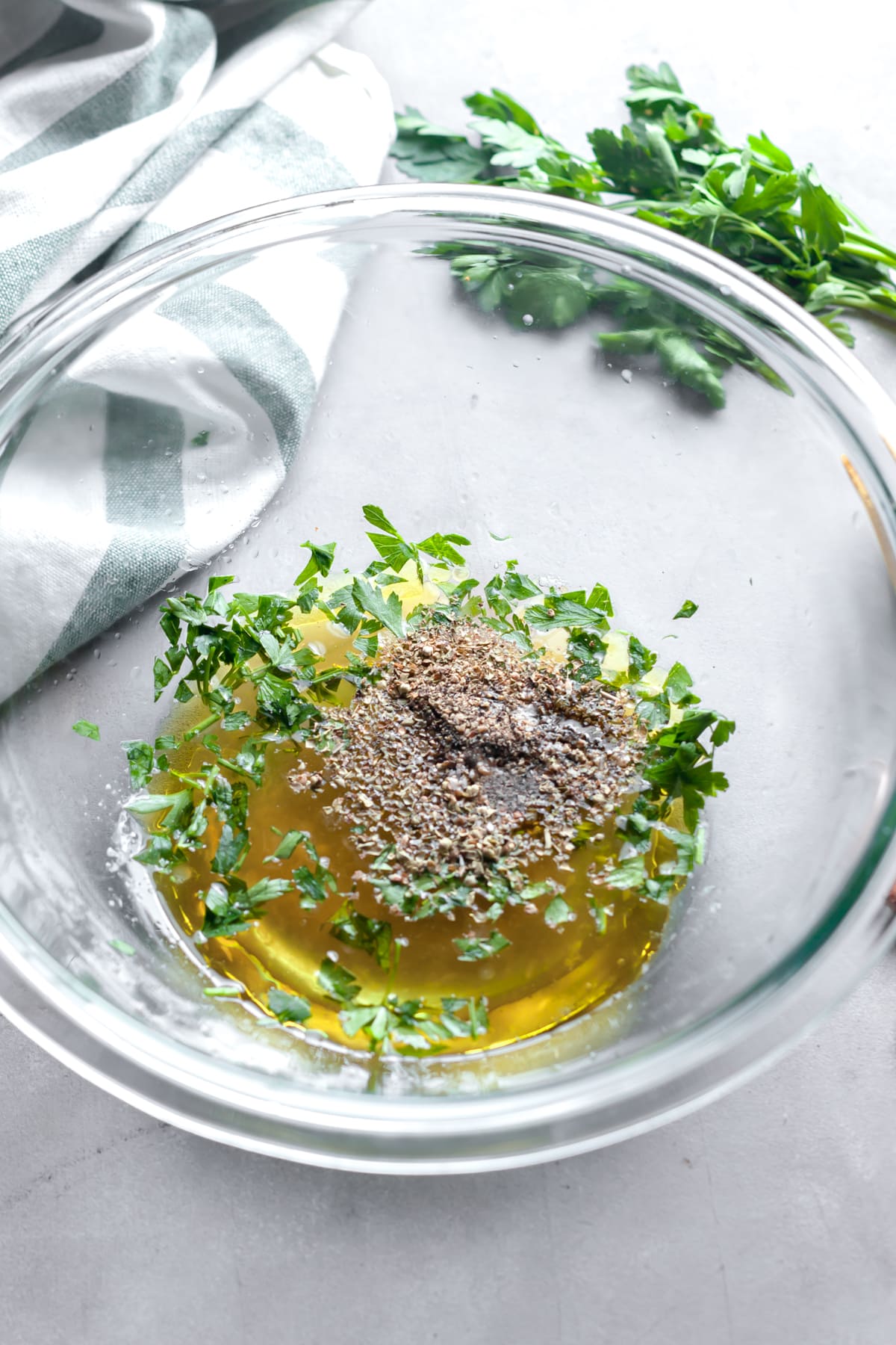 Mixing up homemade spiedies marinade with oil, vinegar, and spices. 