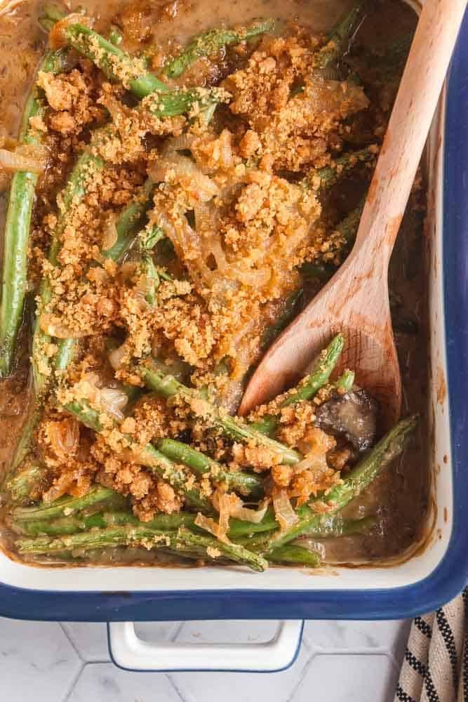 overhead view of a casserole dish of homemade green bean casserole with a spoon in it