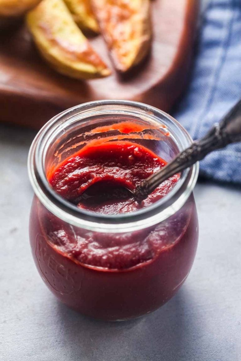 A small glass jar filled with homemade paleo ketchup. 