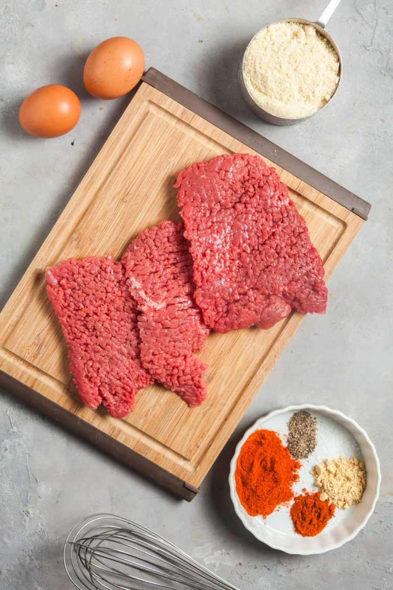 Ingredients for making air fryer finger steaks: cube steak, eggs, almond flour, and spices