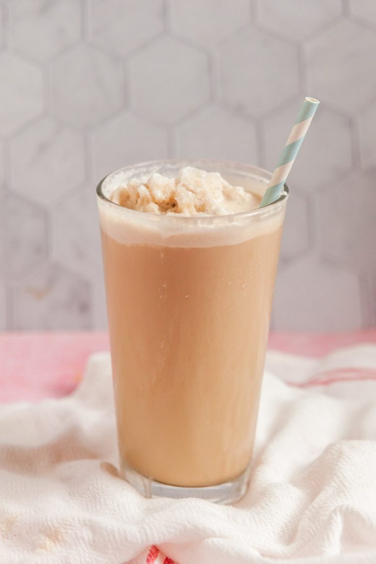 a glass of homemade frozen coffee with a blue and white striped straw