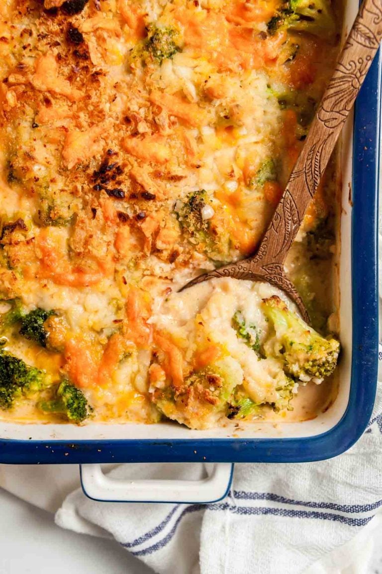 Overhead view of broccoli cheese casserole in a blue baking dish. 