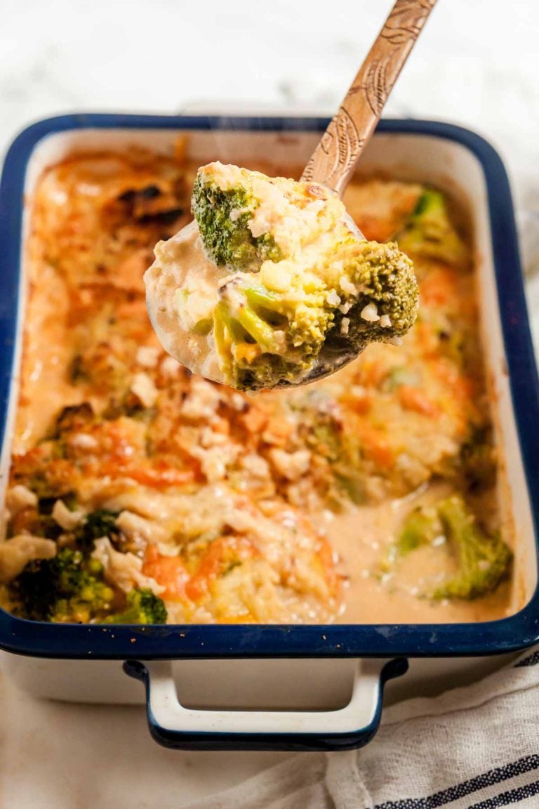 Cheesy broccoli casserole made with wholesome ingredients is a go-to side dish for family dinners! Whether you need a signature dish for the holidays or just want something quick and simple to go along with your air fryer rotisserie chicken,  you're going to love this easy recipe.  Delicious roasted broccoli is blanketed with a rich cheese sauce, topped with a buttery Ritz cracker topping, and baked to perfection. To keep things on the lighter side, I swapped out the traditional rice for cauliflower rice. It adds the perfect texture while keeping the recipe relatively low carb. 