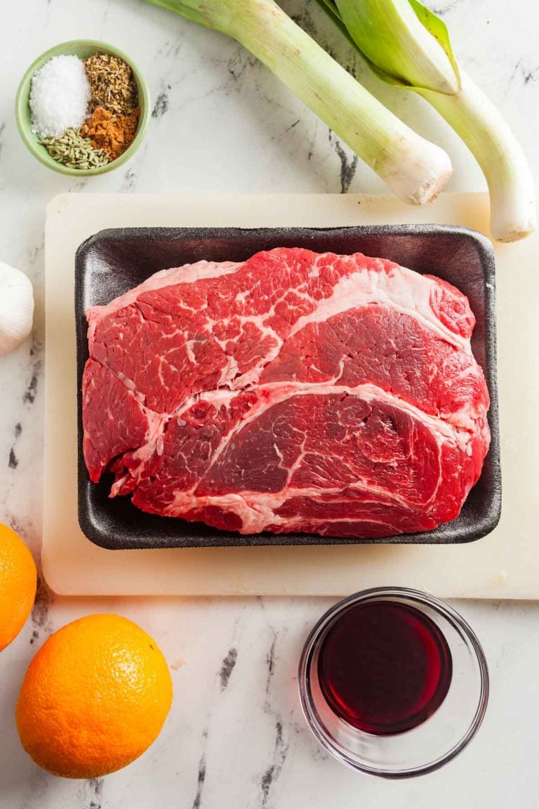 An overhead view of ingredients needed to make homemade beef sausage with orange zest and leeks.