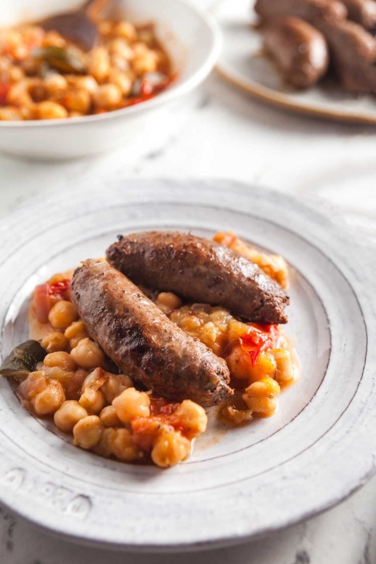 Closeup view of a plate of beef loukaniko sausages.