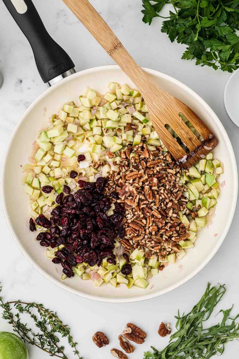 Stirring chopped pecans into the pan for cranberry rice pilaf. 