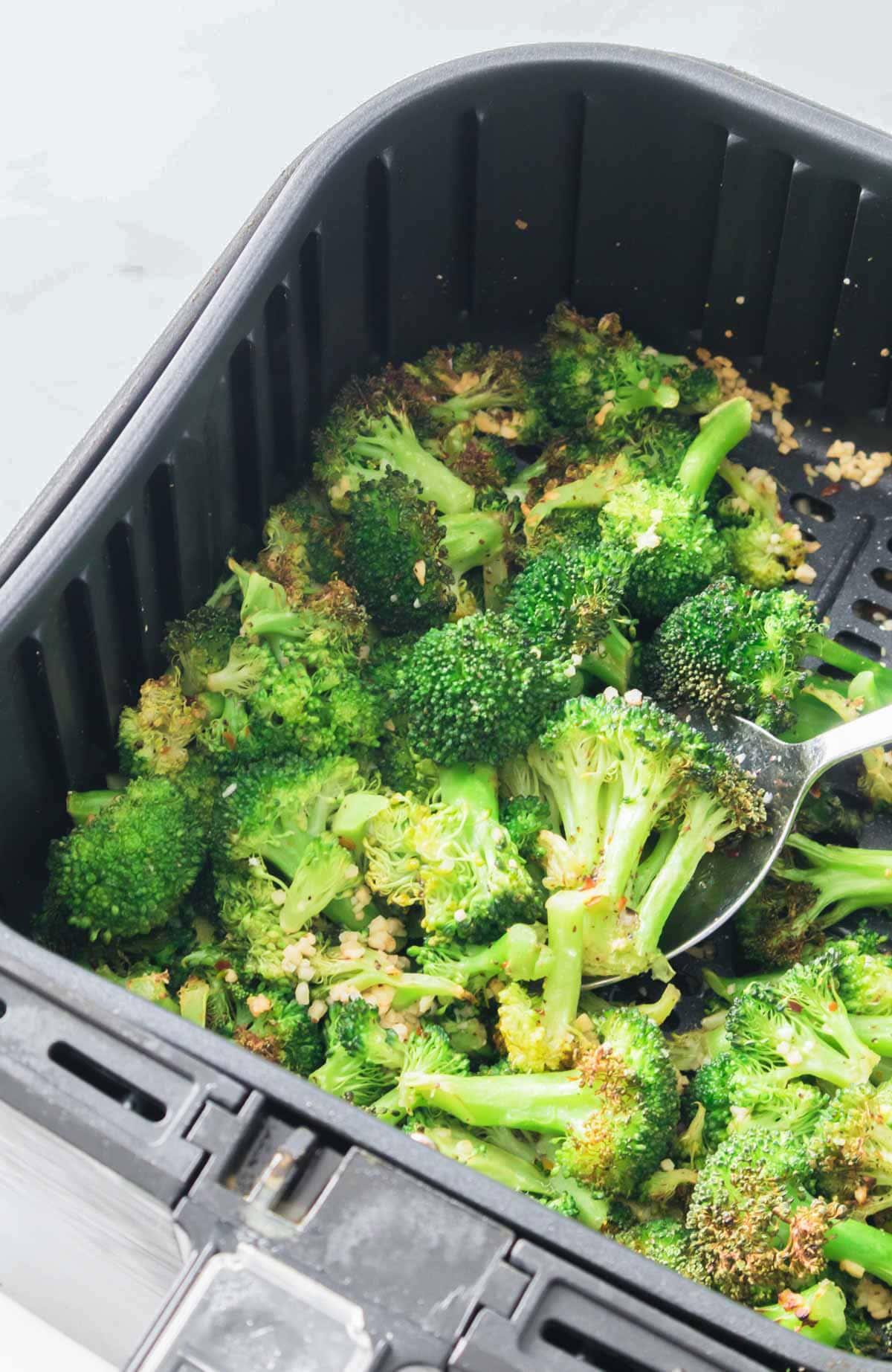 Air fryer broccoli in the basket, ready to be served. 