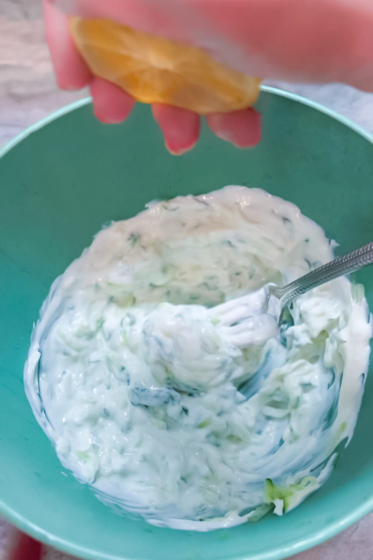 Squeezing lemon into this easy tzatziki recipe. 