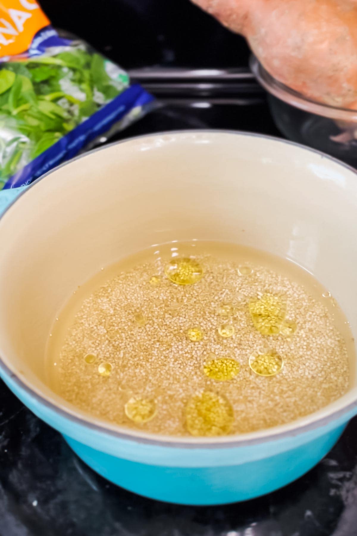 Adding olive oil to quinoa as it cooks gives it more flavor. 