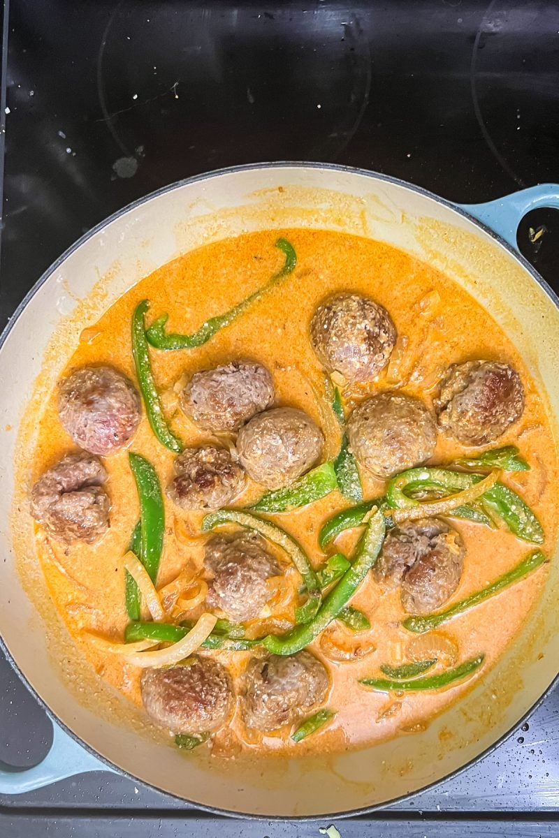 Simmering the coconut curry meatballs. 