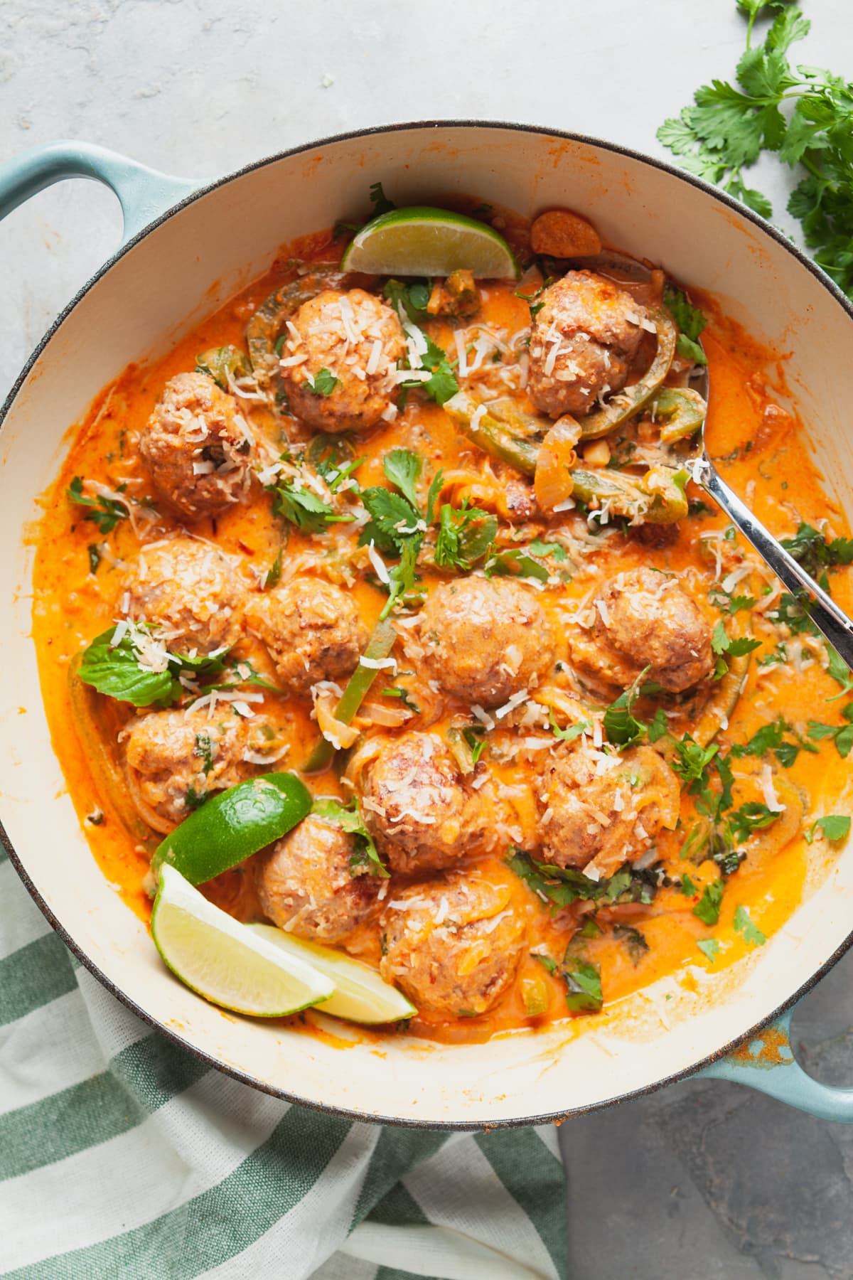 Overhead view of a pan of coconut curry meatballs. 