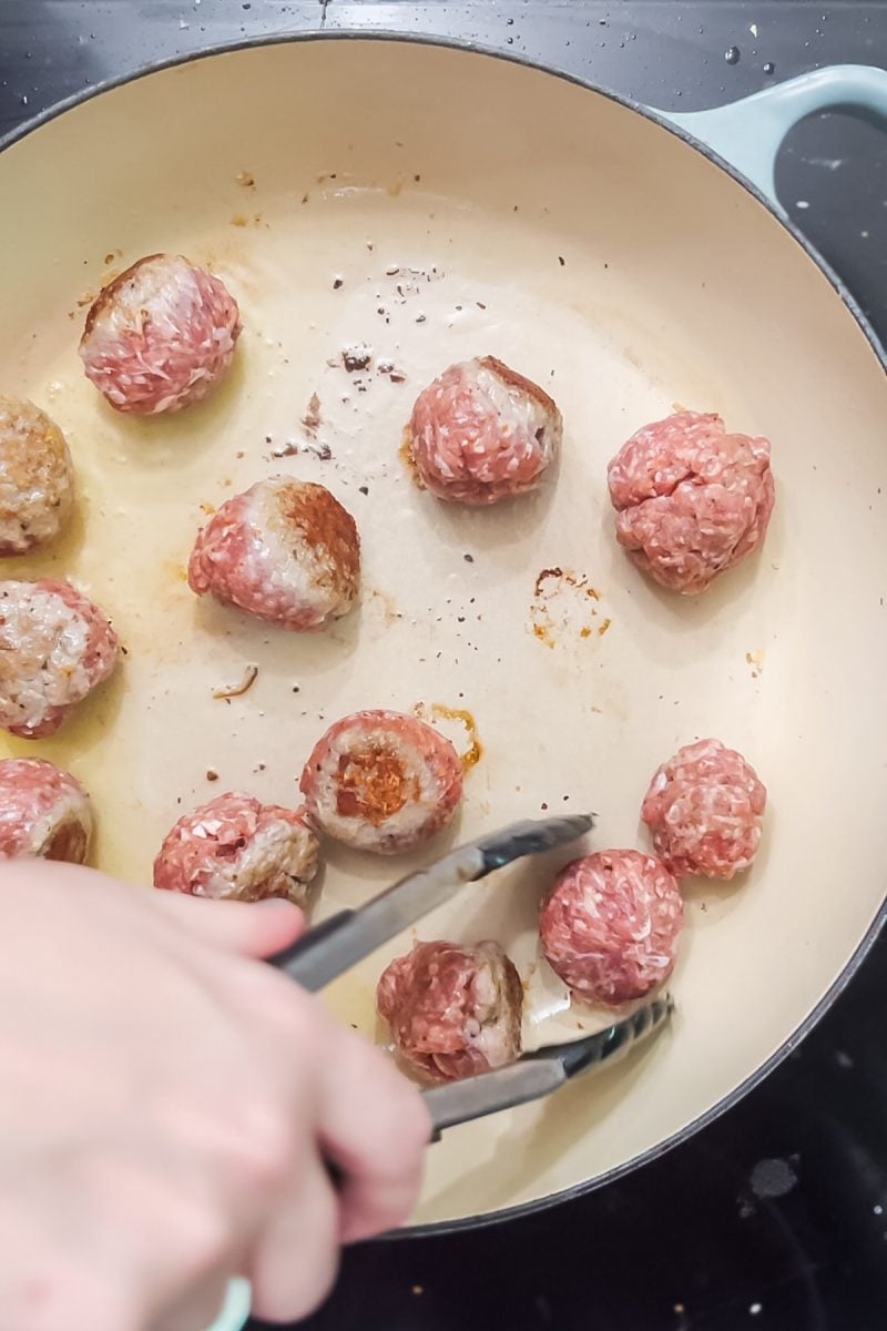 Searing the beef meatballs.