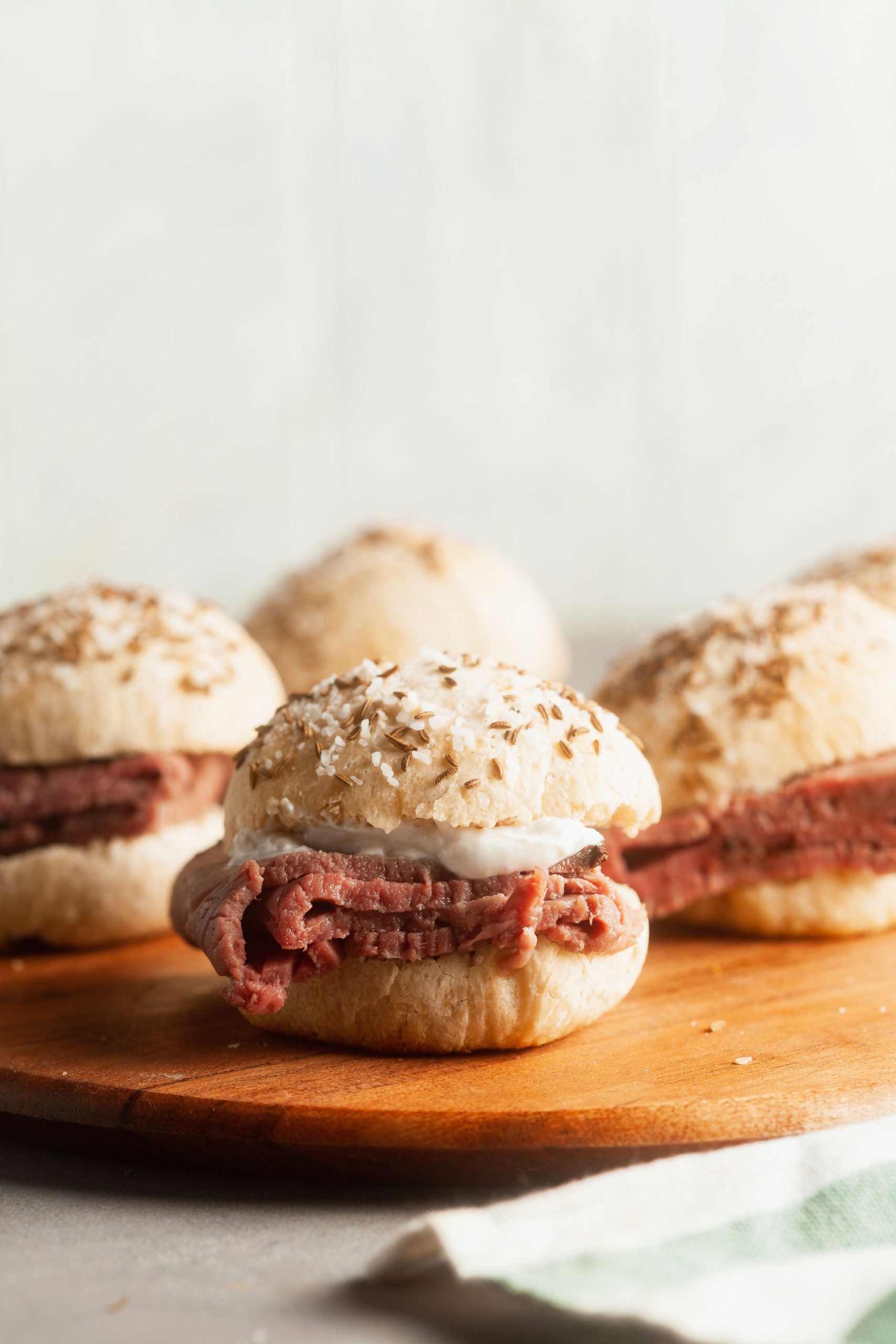 Beef on Weck sliders on a wooden board. 