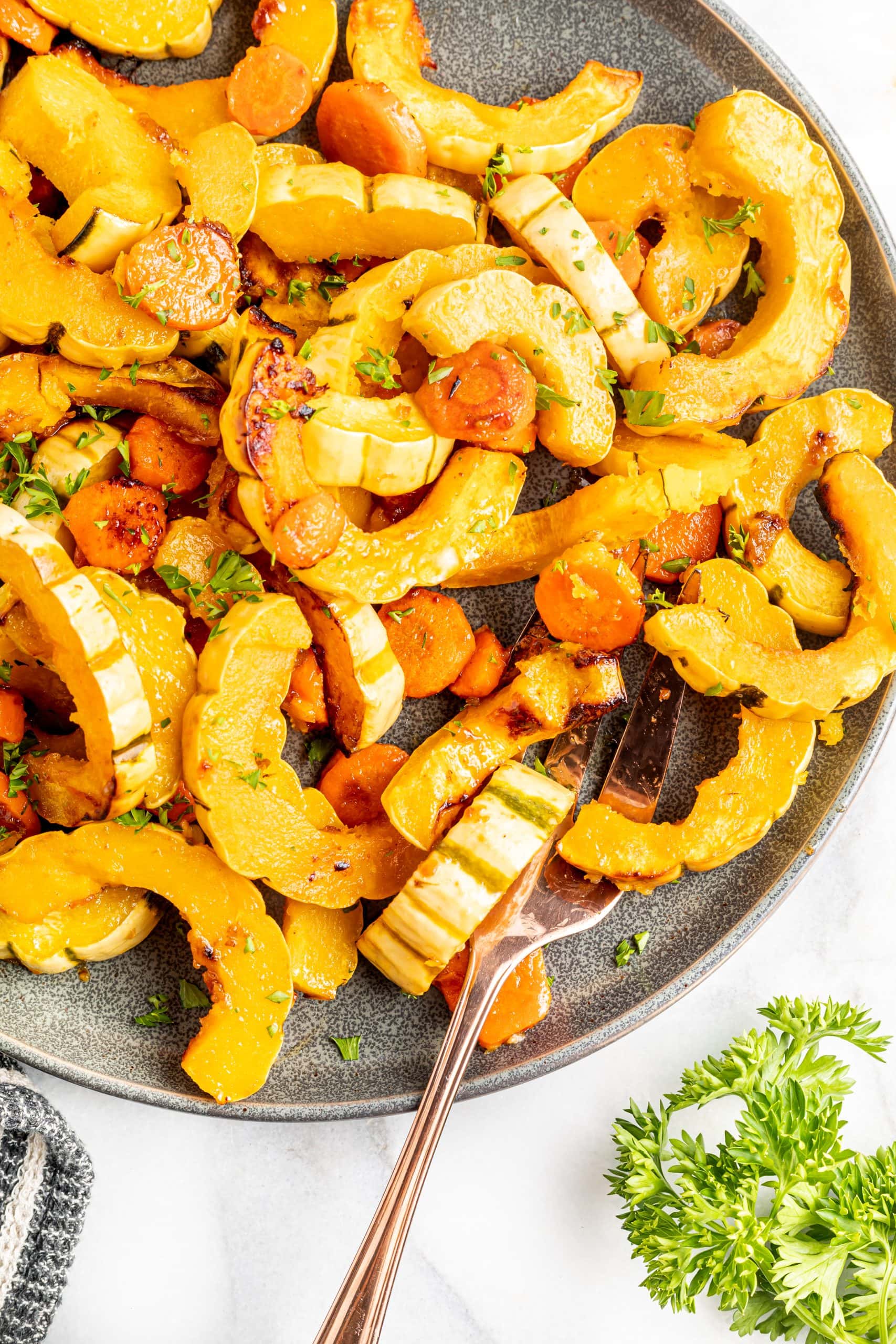 A platter of roasted squash and carrots in a miso and maple glaze.