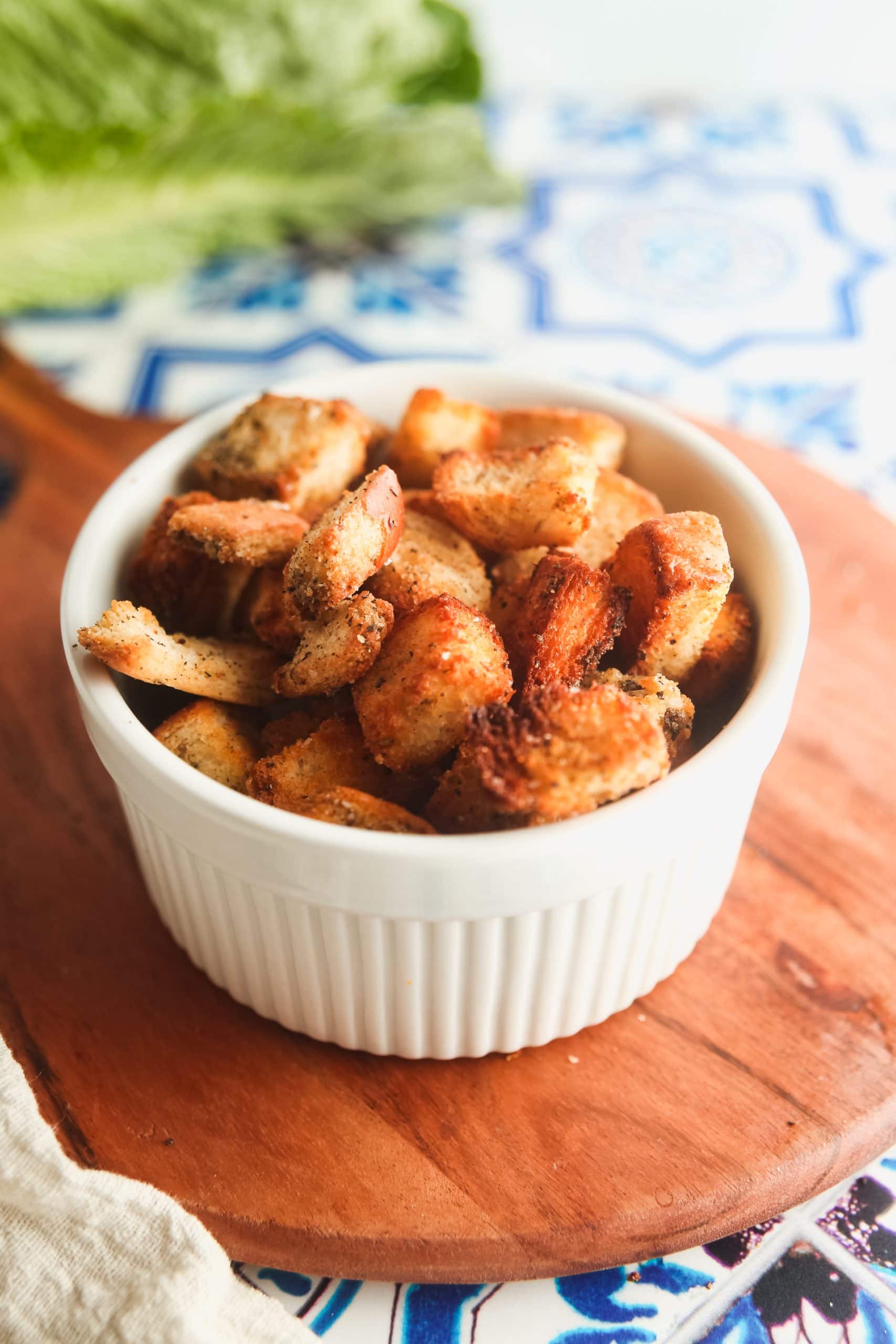 A whiter ramekin filled with sourdough croutons made int he air fryer. 