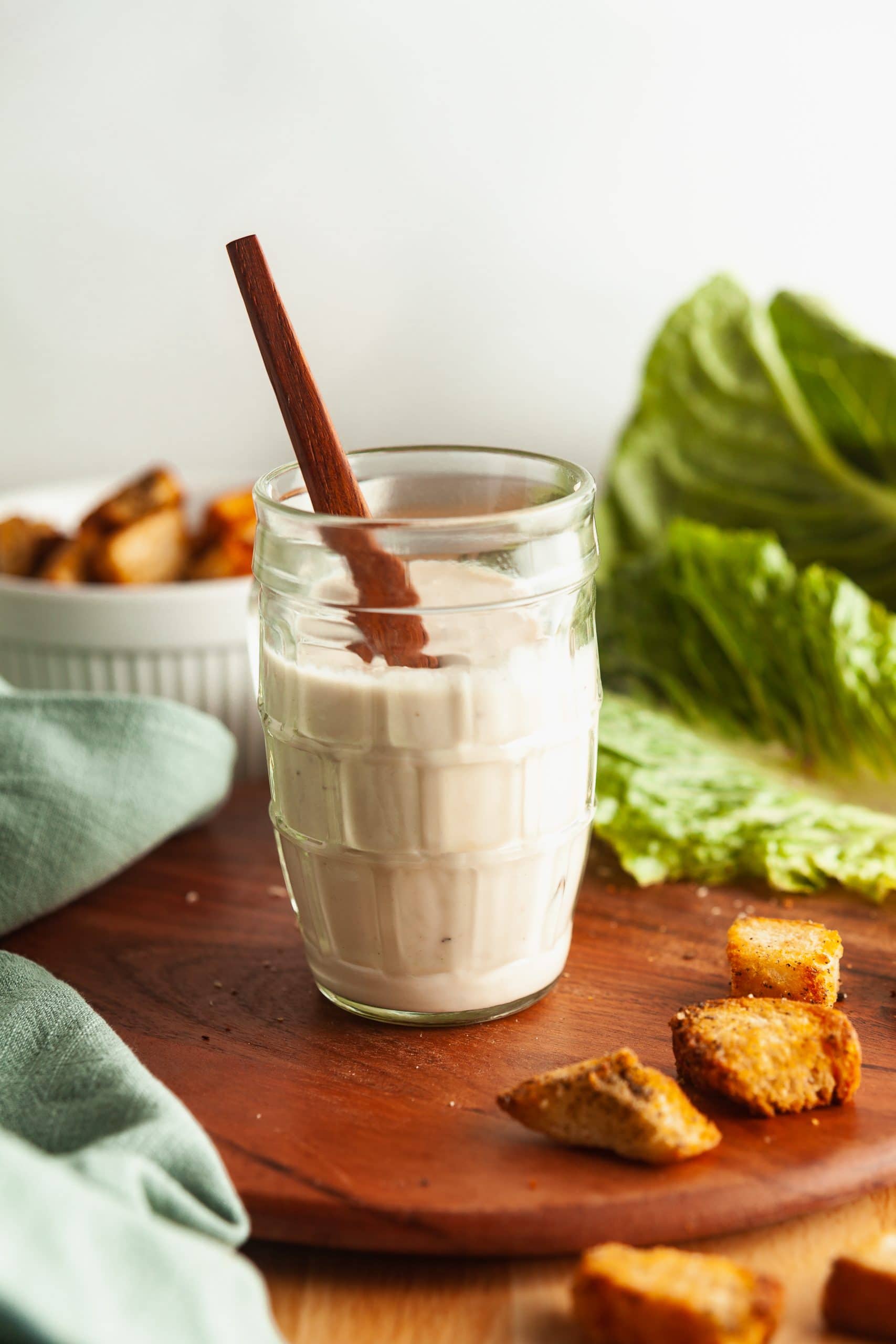 A jar filled with healthy Caesar salad dressing made with Greek yogurt and without mayonnaise. 