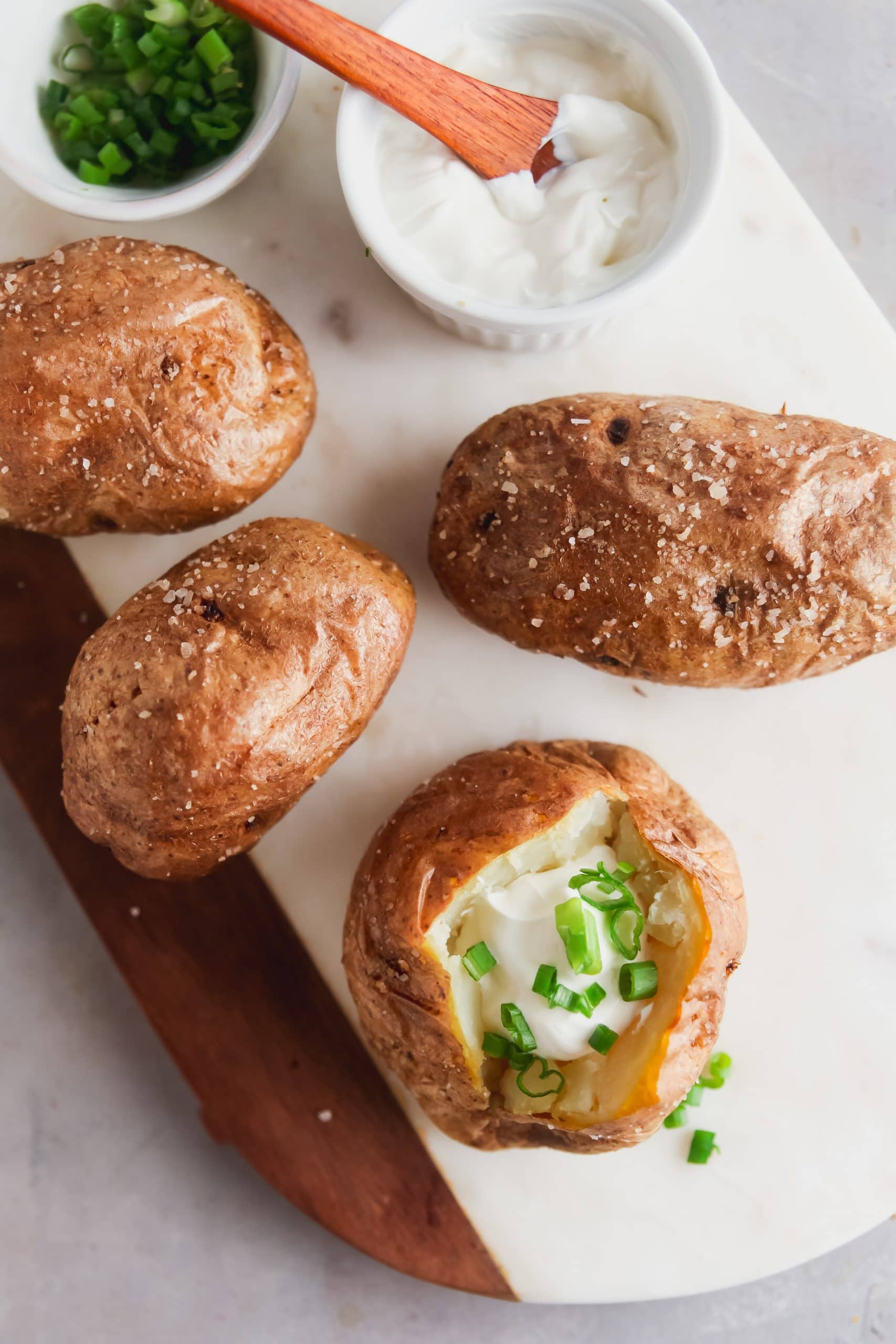 Baked potatoes topped with sour cream and chives. 