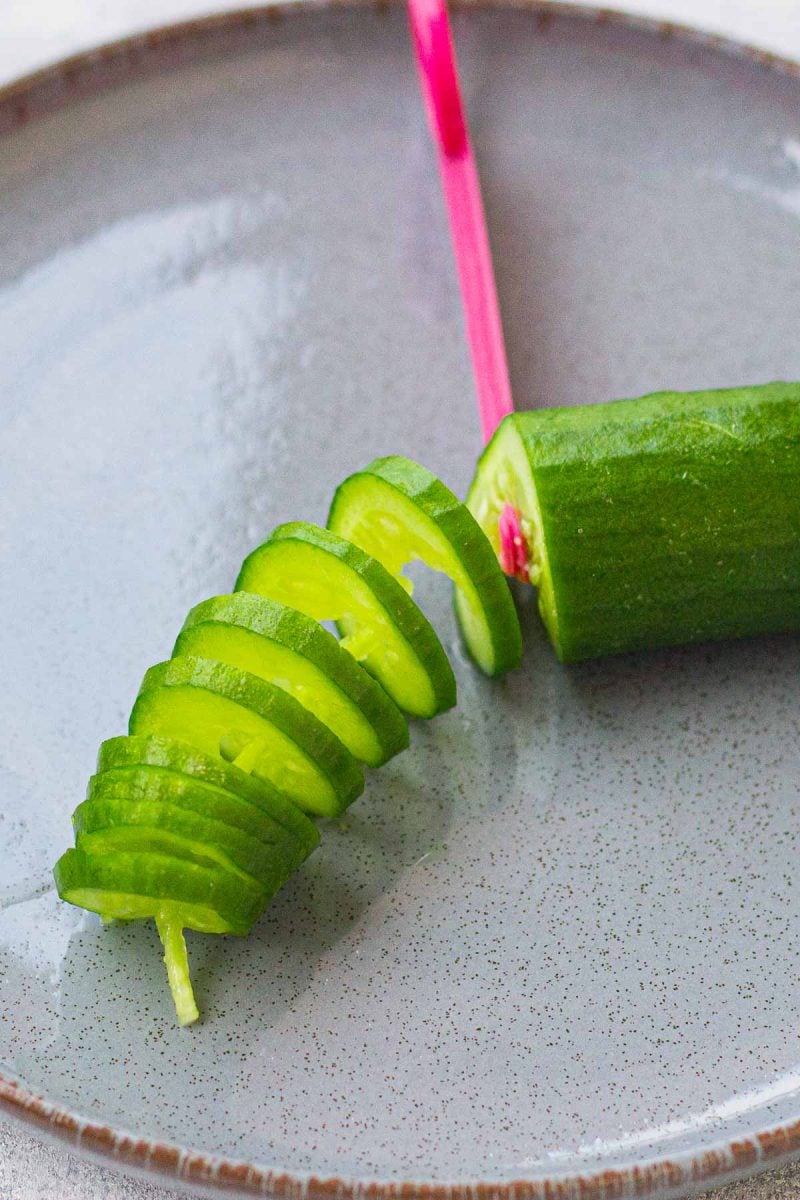 Cutting a cucumber into spirals.