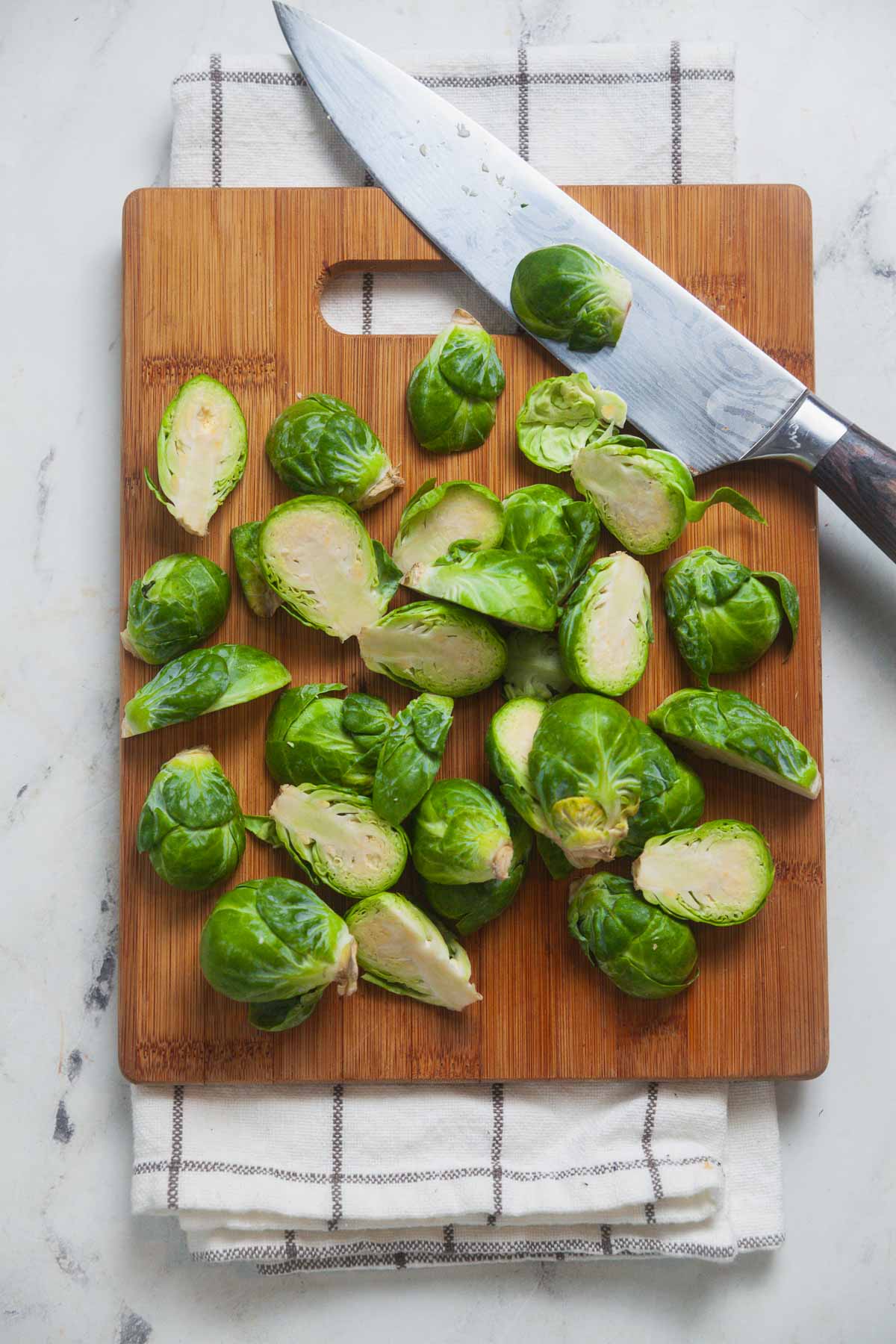 The first step is to cut the sprouts through the stem to a consistent size. 