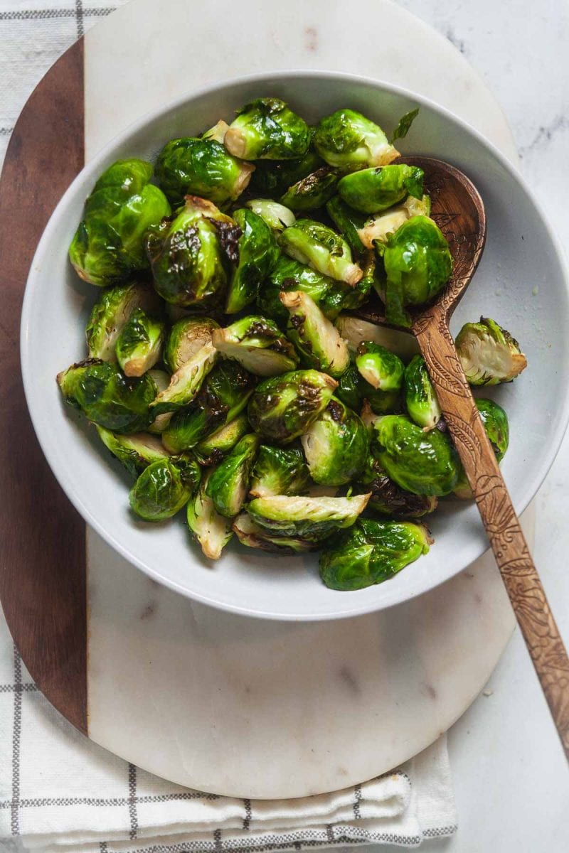 Brussels Sprouts in a white serving dish.