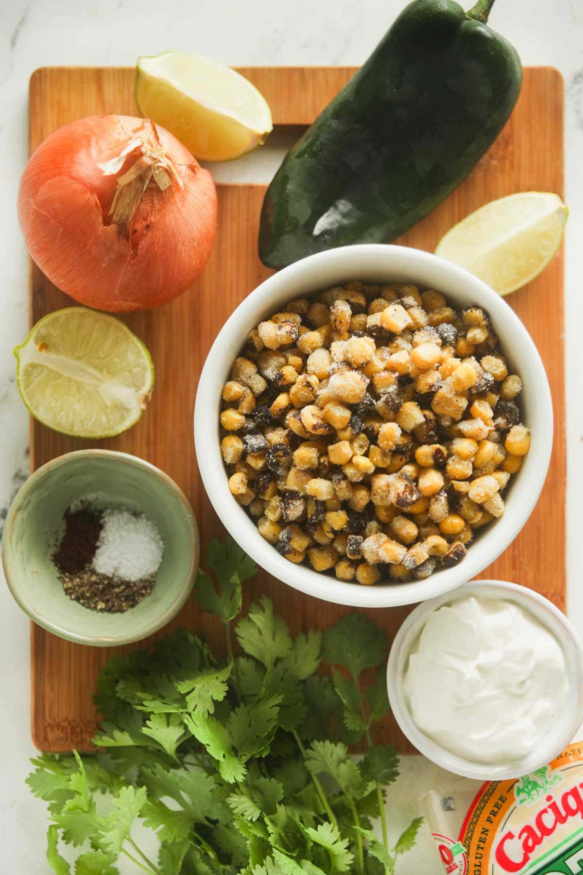 Ingredients needed to make creamy corn chowder inspired by the flavors of Mexican street corn. 
