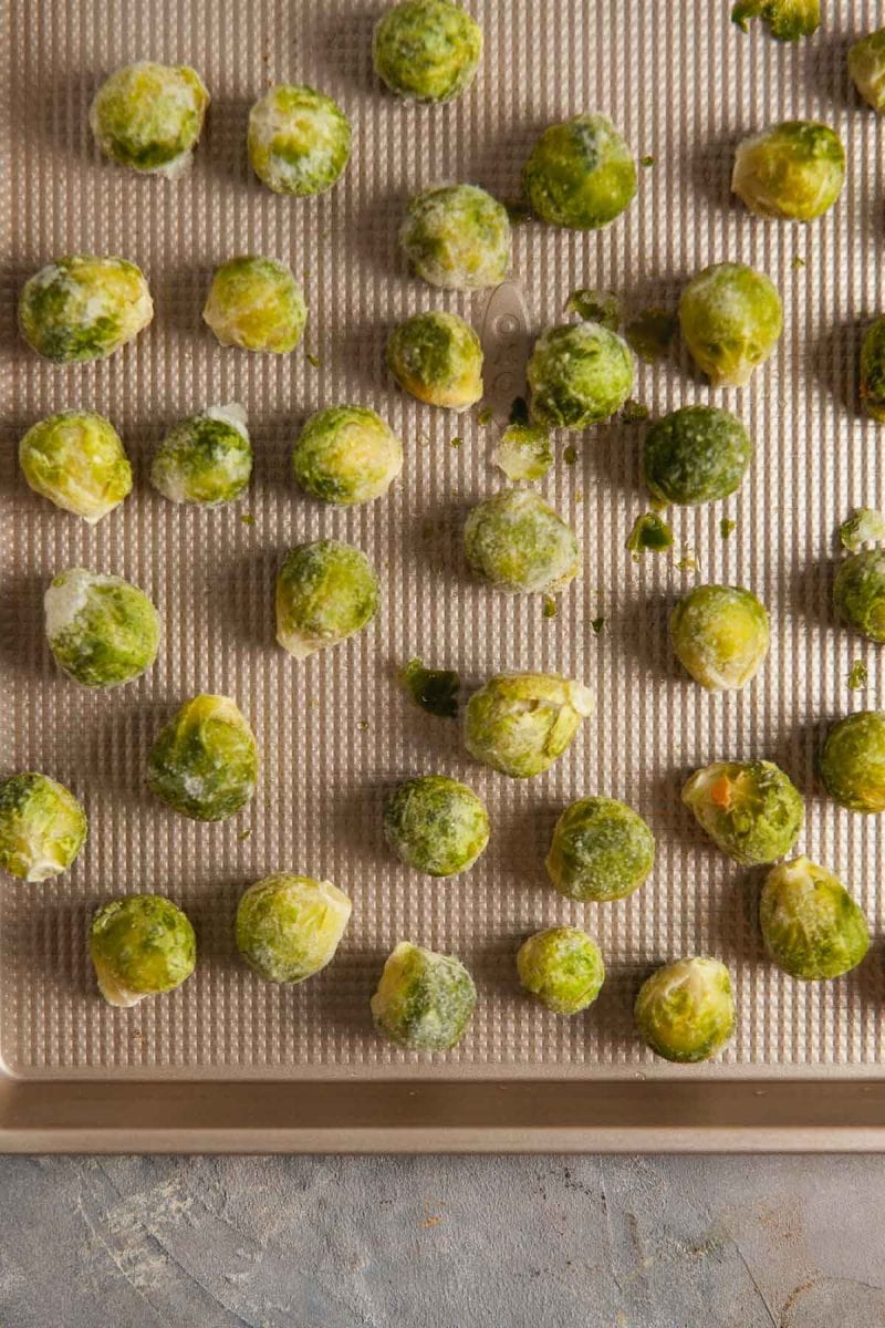 Frozen brussels sprouts on a baking sheet. 
