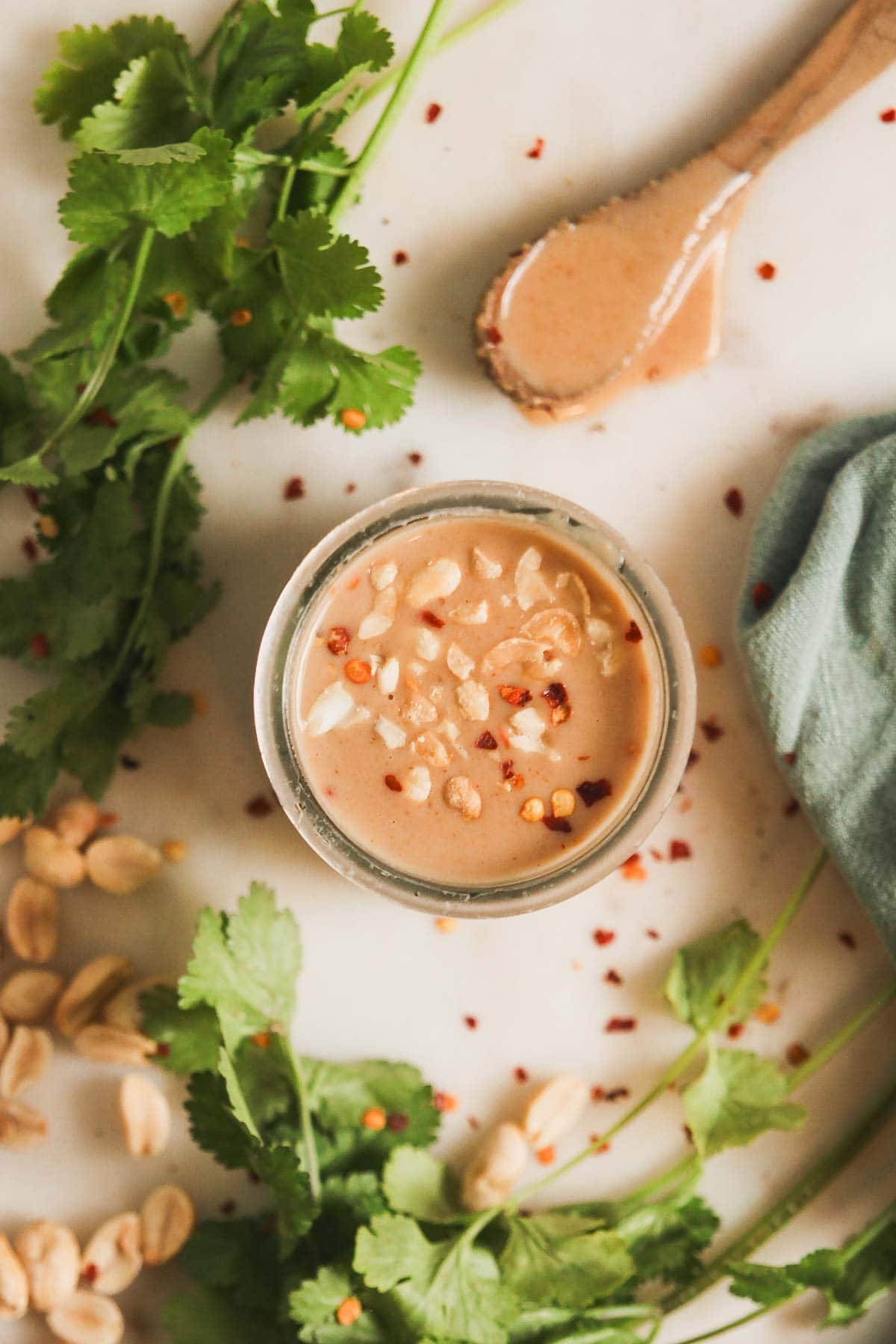 Overhead view of homemade peanut sauce in a jar. 