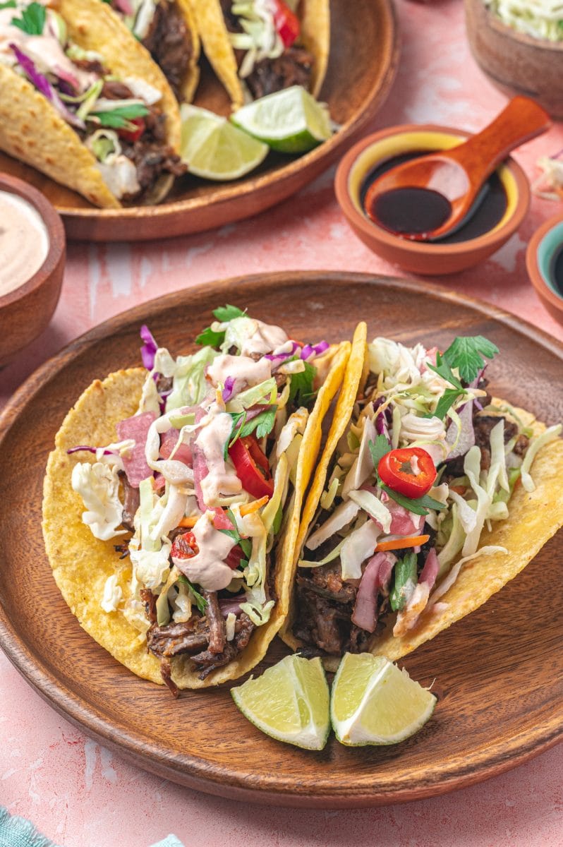 Two Korean short rib tacos on a plate.
